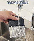 Side view of Segaixlj stainless steel crinkle cutter with black non-slip handle, under running water.