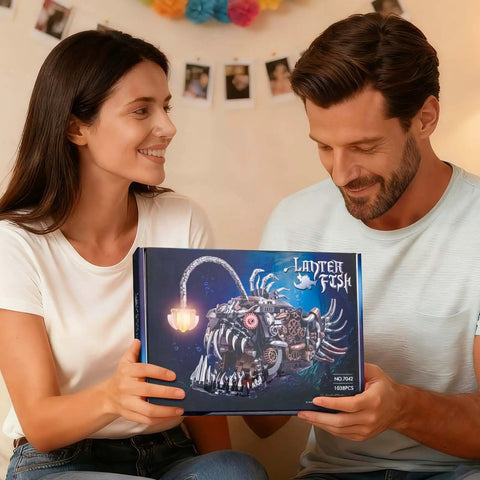 Couple holding Mechanical Anglerfish Building Kit For Adults With Light Display 1038 Piece Set Steampunk Ocean Creature Blocks box