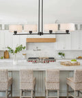 Rectangular Farmhouse Wood Pendant Light With 4 Light Industrial Chandelier over kitchen island with wicker stools and white cabinets