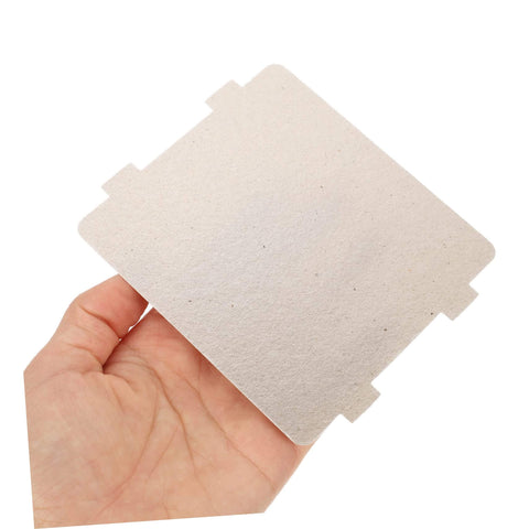 Hand holding a mica sheet from the Ten Piece Microwave Cover And Waveguide Mica Sheets Set For Oven Cavity Insulation And Heat Resistance