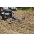 Landscape Rake Attachment For ATV Or UTV, 60 Inch Wide With 17 Tines, Heavy-Duty Yard Leveler clearing debris in field
