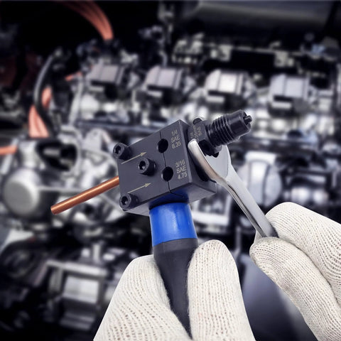 Close-up view of ZUXUSE brake line flaring tool kit in use; copper line inserted into 3/16–1/4 in double flaring tool, gloved hands.
