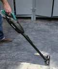 Person using Cordless Vacuum For Workshop And Home, 18V LXT Tool Only, Lightweight Yet Mighty 35 CFM Suction, on workshop floor