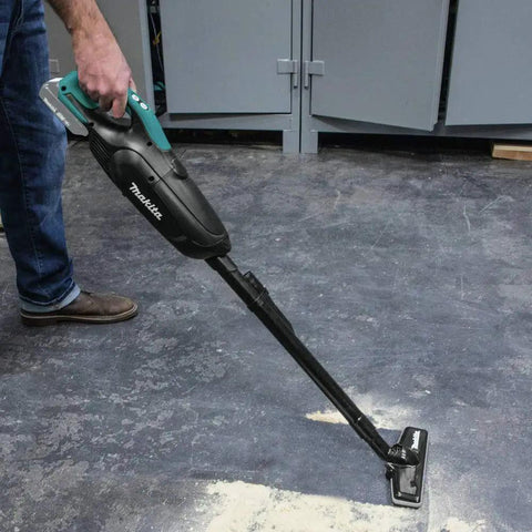 Person using Cordless Vacuum For Workshop And Home, 18V LXT Tool Only, Lightweight Yet Mighty 35 CFM Suction, on workshop floor