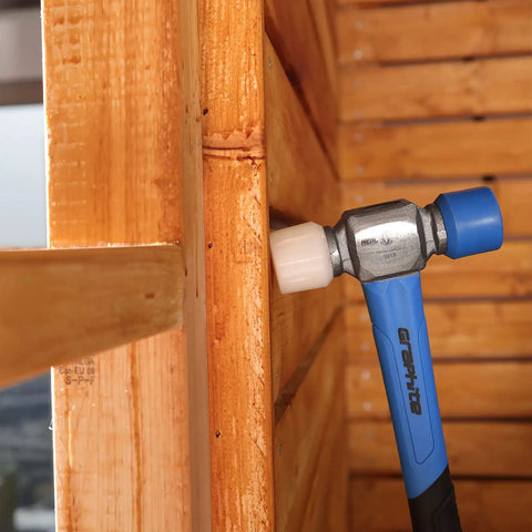 Double Face Rubber Mallet 12 Oz With White Nylon Head And Blue Soft Face in carpentry work on wooden surface