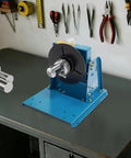 Smooth Operator Heavy Duty Cast Iron Tabletop Welding Positioner With Adjustable Speed Rotation And Lockable Tilt Features For Daily Metal Fab Projects on a workbench.