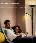 Couple relaxing in living room with Dimmable LED Floor Lamp With 20W Main Light And 5W Reading Lamp, modern black design in warm glow