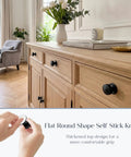 4 Pack Flat Round Self Stick Cabinet Handles Set Matte Black Stainless Steel Adhesive Pulls on a wooden cabinet in living room