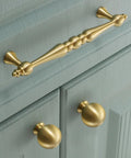Two Pack 5 Inch Center Solid Brass Cabinet Pulls In Vintage Gold Brushed Finish installed on blue cabinet