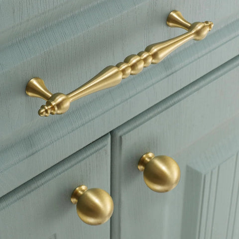 Two Pack 5 Inch Center Solid Brass Cabinet Pulls In Vintage Gold Brushed Finish installed on blue cabinet