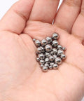 550 Piece Stainless Steel Precision Bearing Balls Kit With 11 Sizes From 0.5mm To 5.5mm For Bike Bearings And DIY Repair Projects A Handy Gearhead Ball Set For Small Mechanical Jobs. stainless steel bearing balls in a hand, mixed sizes for bike bearing repair
