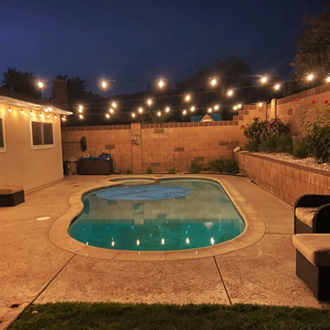 Poolside view with 102Ft Outdoor String Lights 18 Dimmable LED Bulbs, Waterproof Patio Lights illuminating backyard