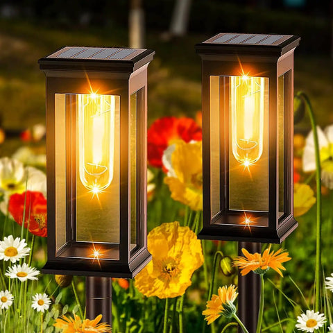 Outdoor Solar Pathway Lights Six Pack Waterproof LED Filament Lamps for Garden Walkways with warm glow in a flower garden