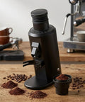 Heavy Duty Eighty Millimeter Flat Burr Coffee Grinder Yields Top Tier Consistent Grounds For Espresso Pour Over And French Press on a wooden table.