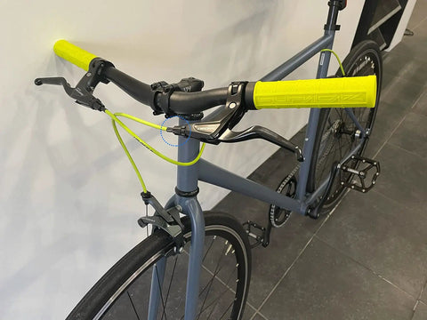 Bicycle with neon yellow handlebar grips and cables featuring 4Mm And 5Mm Aluminum Alloy Bicycle Derailleur Shifter Cable Housing End Caps