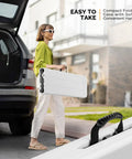 Woman carrying 6 ft folding picnic bench with HDPE tabletop, easy to fold and store, portable for parties, camping, picnics