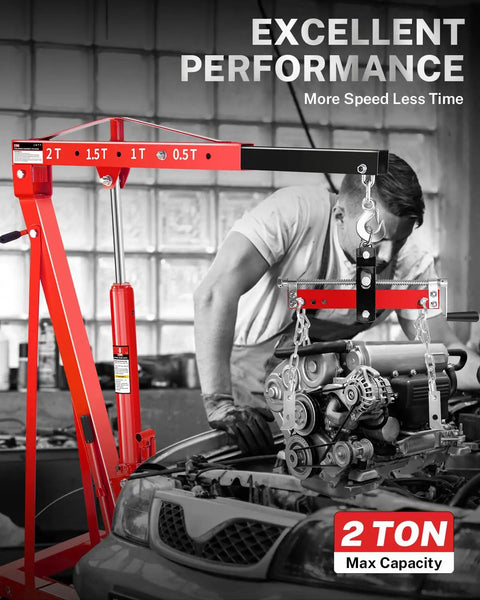 Heavy Duty 2 Ton Hydraulic Engine Hoist Crane With Manual Lever And Compact Folding Design Featuring Four Versatile Boom Positions Rock Solid Locking Wheels For No Sweat Garage Jobs, lifting an engine in a garage.