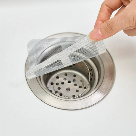 10 Piece Pack Disposable Shower Drain Catcher 3.9 Inch Silver Mesh Filter placed over a sink drain to catch hair and debris.