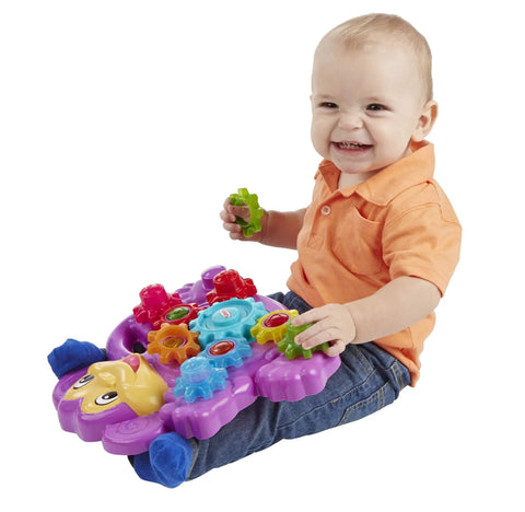 Toddler playing with Totally Awesome Dope Monkey Gears Stacking And Spinning Toy With Nine Interchangeable Plastic Cogs.