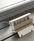 Zebekk push block for table saws, white plastic with tan grip ridges, shown on a metal saw table