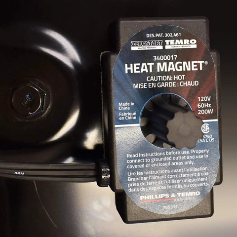 Magnetic Engine Block And Oil Pan Heater With Built In Thermostat 200 Watt detail showing heat magnet unit on metal surface.