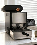 Hella Smooth Electric Coffee Roaster With Zero Hassle Auto Operation And Built In Smoke Filter Chaff Collector Plus Chimney Tube on countertop.