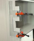Rock Solid Heavy Duty Adjustable Wood Drawer Slide Jig With Dead On Positioning Clips clamped to a cabinet edge for precise alignment.