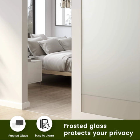 Frosted Glass Bifold The Doors pre-finished sliding MDF white interior door shown partly open in a bedroom setting with privacy.