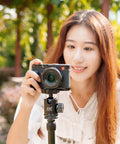 Woman using camera with Durable Aluminum Hand Grip For D-LUX8 Camera With L Shape Bracket And Built In Arca Quick Release Plate outdoors
