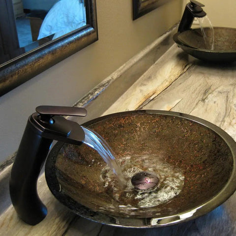 Cascade Waterfall Vessel Faucet With Single Lever Handle, Oil Rubbed Bronze Finish, Solid Brass Construction shown in bathroom setting