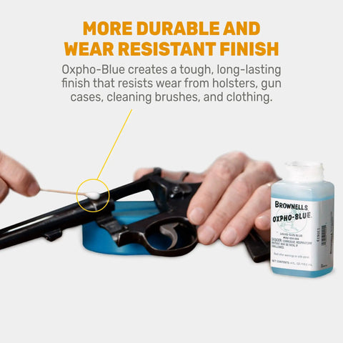 Person applying Oxpho-Blue Liquid Gun Blue Cold Bluing Solution For Gunsmithing And Maintenance, 4 Fl Oz bottle nearby.