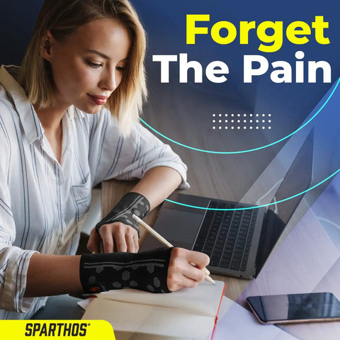 Woman using laptop and writing while wearing Wrist Support Sleeves Pair For All Day Pain Relief, Medical Grade Compression.