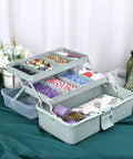 Clear 3 Layer Plastic Dividing Storage Box With Adjustable Spacers Portable Handle Craft Organizer For Art Supplies Medicine Sewing And Home Utility Multipurpose Box In Haze Green displaying various craft items.