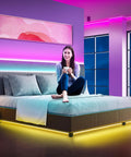 Woman in bedroom with Two Rolls 130 Ft LED Strip Lights For Bedroom Color Changing Lights With Music Sync App Control And Remote