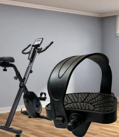 Beefed Up Anti Slip Exercise Bike Pedals With Nine Sixteenth Inch And One Half Inch Spindles Adjustable Straps Fits Peloton Schwinn And Spin Bikes 500 Pound Capacity Military Grade Durable PP Construction, shown with a stationary bike in the background.