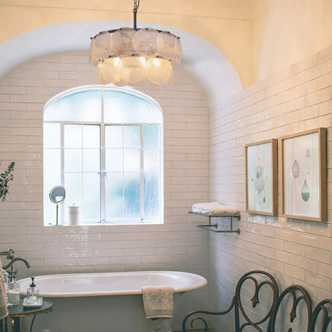 Two-Tier Farmhouse Glass Chandelier With Seeded Glass Shades in cozy bathroom setting, creates warm glow with modern style.