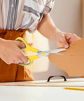 Person cutting cardboard with 6 Pack 8 Inch All Purpose Heavy Duty Scissors Bulk Set for Office, School, and Classroom Use, Sharp Blades