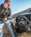 Man using Hub Wireless Receiver for Truck, SUV and Jeep Winches with Bluetooth Control on off-road Jeep winch setup