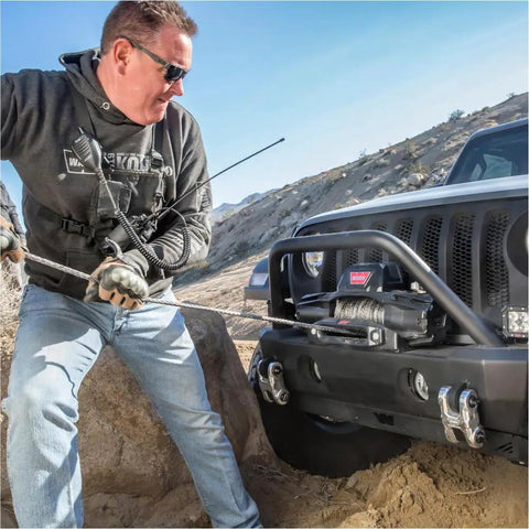 Man using Hub Wireless Receiver for Truck, SUV and Jeep Winches with Bluetooth Control on off-road Jeep winch setup