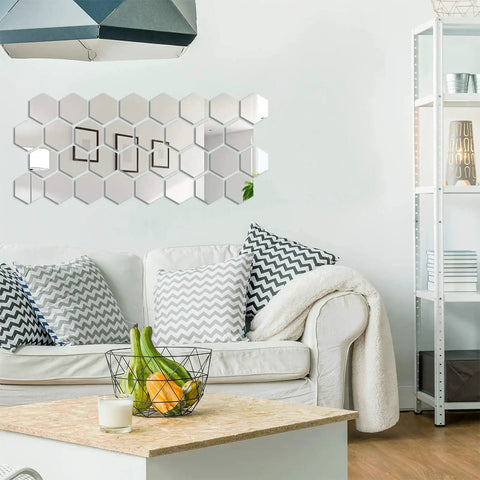 24 Piece Dope Hexagon Mirror Wall Sticker Set displayed above a sofa in a living room, showing reflective acrylic honeycomb mirrors