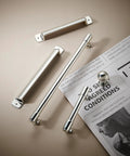 10 Pack 2-1/2 Inch Polished Nickel Drawer Pulls Cabinet Cup Pulls Kitchen Hardware Bin Cup Drawer Pulls on a beige surface