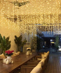 Warm White LED Icicle String Lights For Windows And Outdoor Spaces 16.4Ft 216 LEDs illuminating outdoor patio area