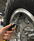 Locking Air Chuck With Six Steel Jaws inflating tire for hands free use, attached to a Schrader valve, open flow up to 150 PSI