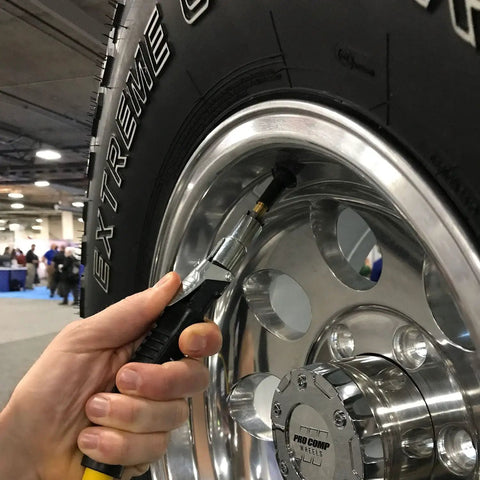 Locking Air Chuck With Six Steel Jaws inflating tire for hands free use, attached to a Schrader valve, open flow up to 150 PSI