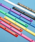 Various colored Rib Bones Rails For Skateboards displayed on blue surface, including purple ABS plastic for smoother rides.