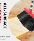 Heavy Duty Angle Broom With Adjustable Handle And Wide Brush Head Built Like A Beast To Clean Concrete Patios Garages And Driveways Without Breaking A Sweat Two Pack Black Red sweeping dust from wood surface.