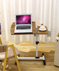 Slick Rolling Laptop Desk With Totally Adjustable Height And Easy Tilt Panel, medium fiberboard top, laptop and coffee on side table.