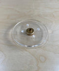 Close up of a six inch round clear acrylic router base plate with pre drilled holes for RT0701C or XTR01Z models.