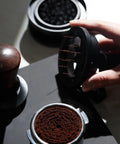 Level Up Your Daily Brew Game With This Dope 10 Needle Espresso WDT Distribution Tool And Rotary Dosing Funnel in use with espresso grounds.