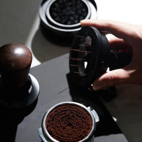 Level Up Your Daily Brew Game With This Dope 10 Needle Espresso WDT Distribution Tool And Rotary Dosing Funnel in use with espresso grounds.